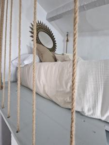 a bedroom with a hanging bed with a mirror at El Pitijopo in El Gastor