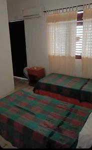 Ein Bett oder Betten in einem Zimmer der Unterkunft Pousada jardim de cabo branco