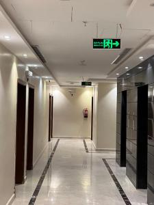 a hallway in a building with a sign on the ceiling at فندق قافلة الحجاز in Mecca