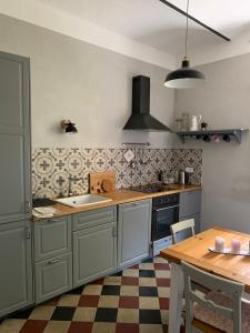 a kitchen with a sink and a wooden table at San domenico 18 in Florence