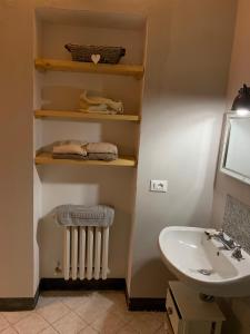 a bathroom with a white sink and a radiator at San domenico 18 in Florence