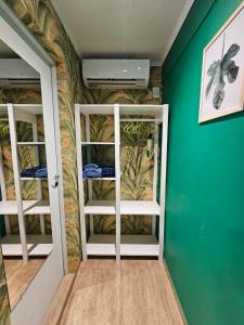 a room with two bunk beds in a room with green walls at Casa 24 Puerto Iguazu in Puerto Iguazú