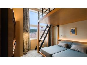 a bedroom with a bunk bed with a ladder at GRIDS Premium Hotel Otaru - Vacation STAY 68539v in Otaru +26 photos