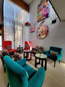 a living room with chairs and tables and a tv at 3B Barranco's - Chic and Basic - B&B in Lima