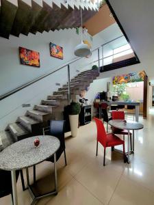 a room with tables and chairs and a staircase at 3B Barranco's - Chic and Basic - B&B in Lima