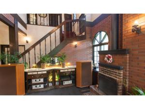 a room with a staircase and a brick wall at Restaurant & Hotel Traumerei - Vacation STAY 47777v in Hakuba