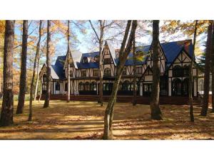 a large house with trees in front of it at Restaurant & Hotel Traumerei - Vacation STAY 47795v in Hakuba