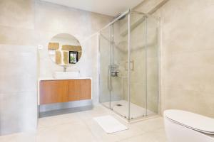 a bathroom with a shower and a sink at Loriga View Apartments in Loriga