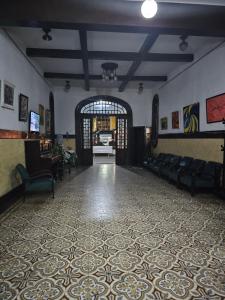 a large room with a lobby with couches and a large doorway at Varzea Palace Hotel in Teresópolis
