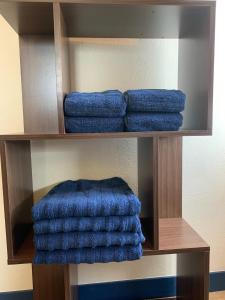 a group of blue towels on a wooden shelf at Kawamura Building 3F - Vacation STAY 47042v in Kusatsu