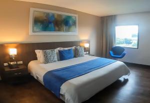 Postel nebo postele na pokoji v ubytování Hotel Royal Elim International