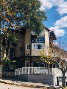 a building with a sign on the front of it at Hotel Solar da Montanha in Campos do Jordão