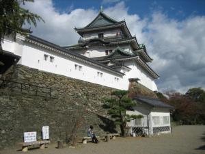 a person sitting on a bench in front of a castle at Business Hotel Katsuya - Vacation STAY 62197v in Wakayama