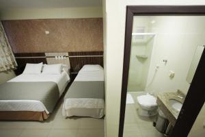 Postel nebo postele na pokoji v ubytování Hotel Real