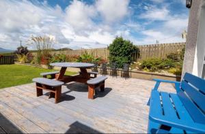 a picnic table and two benches on a patio at Anne’s House in Dunfanaghy