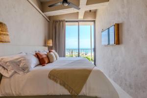 a bedroom with a large bed with a large window at Bondo Hometel in Cartagena de Indias