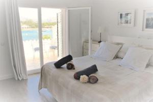 a bedroom with a bed with two stuffed animals on it at CASA PRINCESA in Alcudia