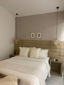 Ένα ή περισσότερα κρεβάτια σε δωμάτιο στο Moet Medellin Hotel