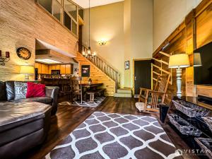 a living room with a couch and a table at Premium Ski In Ski Out At Giants Steps Chairlift! in Brian Head