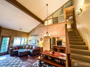 a living room with a couch and a staircase at Premium Ski In Ski Out At Giants Steps Chairlift! in Brian Head