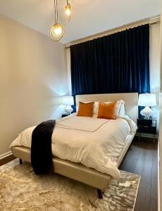 a bedroom with a large bed with orange pillows at NEW! Spacious Art Deco Modern 5 BD/3BA Condo in Chicago