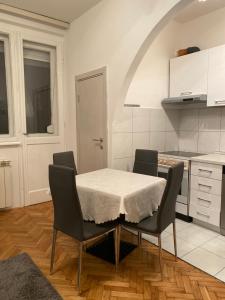 a kitchen with a table and chairs in a room at Apartment Tilia Center Belgrade in Belgrade