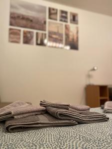 two folded towels sitting on top of a bed at Apartment Tilia Center Belgrade in Belgrade