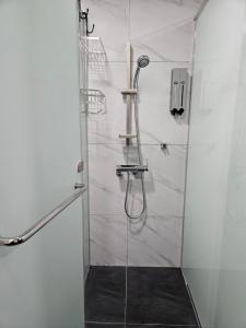 a bathroom with a shower with a glass door at Philstay Myeongdong Boutique Female in Seoul +30 photos