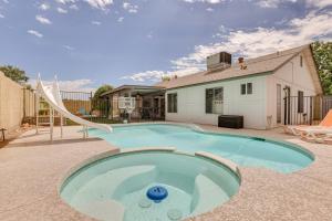 a swimming pool with a slide in a yard at Family-Friendly Peoria Home with Pool and Fire Pit! in Peoria