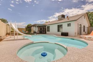 a swimming pool with a slide in a yard at Family-Friendly Home with Pool and Fire Pit in Peoria in Peoria