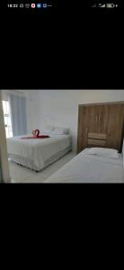 two beds sitting next to each other in a bedroom at DUPLEX 5 ESTRELAS A 100 METROS DA PRAIA in Porto Seguro