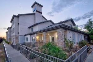 a large white building with a clock tower on top at Studio 6-Bakersfield, CA in Bakersfield