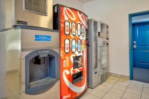 a coke machine in a room with a vending machine at Studio 6-Bakersfield, CA in Bakersfield