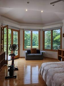 a bedroom with a bed and a couch and windows at Greensboro Lakefront House -K Idol House in McLeansville