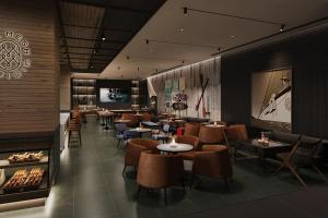 a restaurant with tables and chairs and a fireplace at Four Points by Sheraton Nantong, Haimen in Nantong