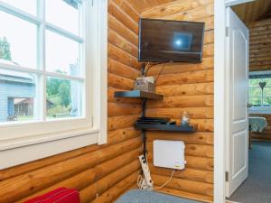 a room with a wooden wall with a television on it at 6 person holiday home in Hovborg-By Traum in Hovborg