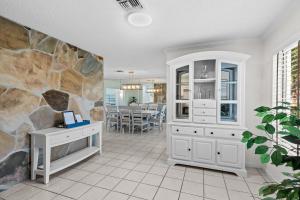 a home office with a stone wall at Solar Heated Pool Spa Tiki Hut Huge Backyard Hammock Retro Bikes in Pompano Beach