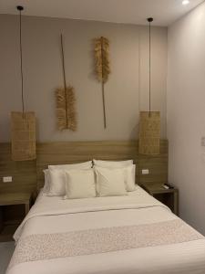 Ένα ή περισσότερα κρεβάτια σε δωμάτιο στο Moet Medellin Hotel