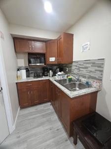 a small kitchen with wooden cabinets and a sink at Home in Winnipeg