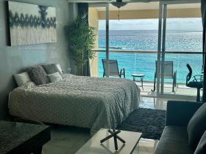 a bedroom with a bed and a view of the ocean at Beachfront Penthouse (best location, 3 beds, 2 balconies) in Cancún