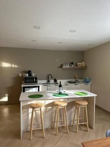uma cozinha com dois bancos de bar e um balcão em Habitación 21 - Green Casitas em Ensenada
