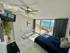 a bedroom with a bed and a view of the ocean at Beachfront Penthouse (best location, 3 beds, 2 balconies) in Cancún