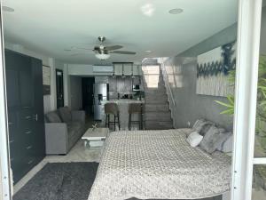 a bedroom with a bed and a living room at Beachfront Penthouse (best location, 3 beds, 2 balconies) in Cancún