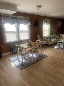 a living room with a table and chairs and a couch at Queens chateau in Laurelton
