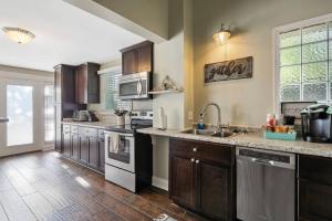 a large kitchen with wooden cabinets and a sink at Haymount Hideaway in Fayetteville
