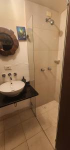 a bathroom with a sink and a shower at Portelli Hostal Zona G in Bogotá