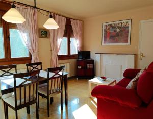 a living room with a table and a red couch at ATALAYA DEL RÍO in Valderrobres