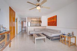 a living room with a couch and a ceiling fan at Port Royal ocean view apartment in Los Cristianos in Los Cristianos