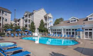 a swimming pool with lounge chairs and a hotel at 2 Bedroom Deluxe Villa at the Wyndham Nashville Resort in Nashville