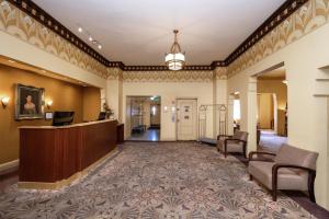 a lobby of a hotel with a reception desk and chairs at The Baroness Hotel in Seattle